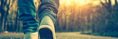 Close-up photo of someone walking on the road
