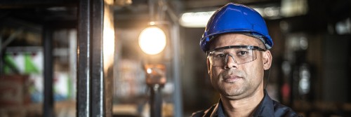 Hispanic male factory worker with confident/serious expression