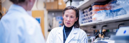 Dr. Katharine Hsu converses with a colleague.